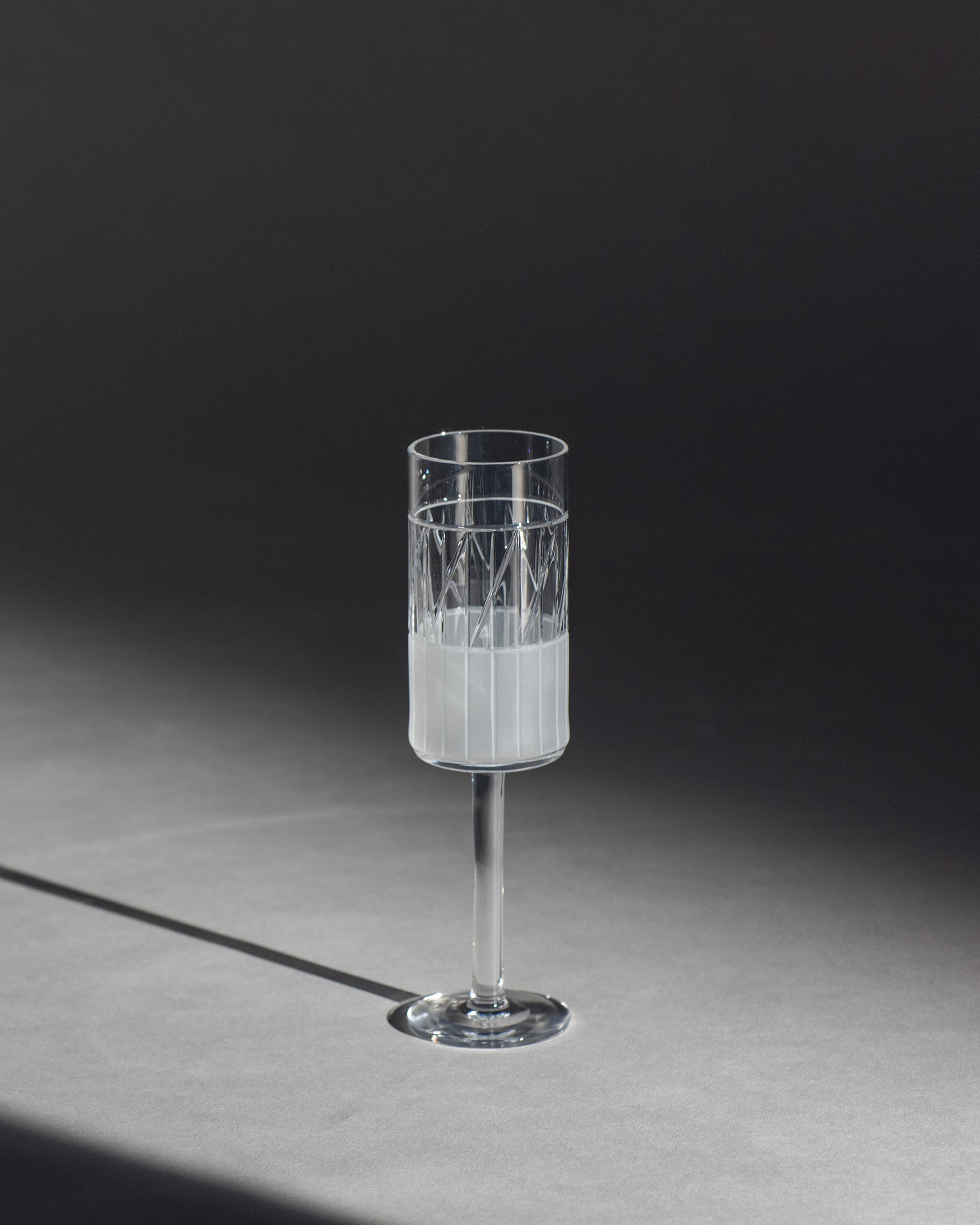 Hand-cut Irish crystal champagne glass from the Thorn Collection, featuring sharp linear cuts and sculptural design, ideal for sparkling wine, cocktails, or celebratory drinks on an ambient background