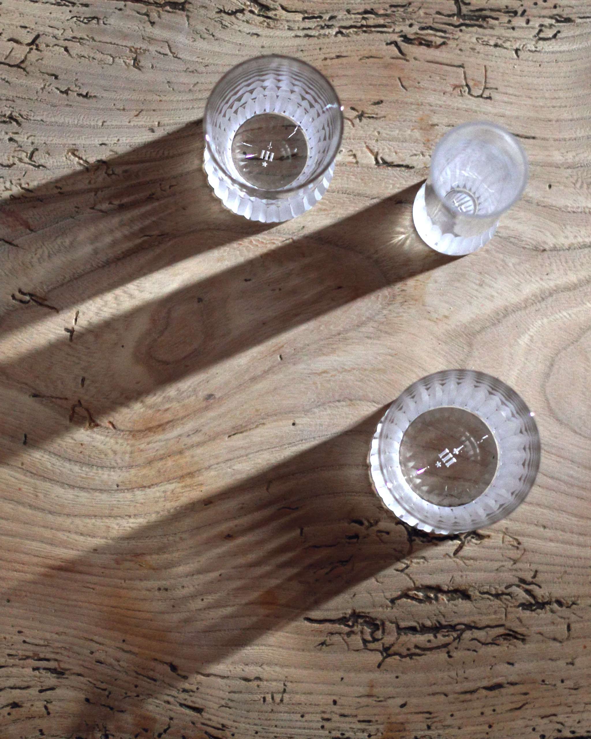 Array of Irish hand-blown cut crystal glasses pictured from above to highlight distinct cut detailing and etched branding