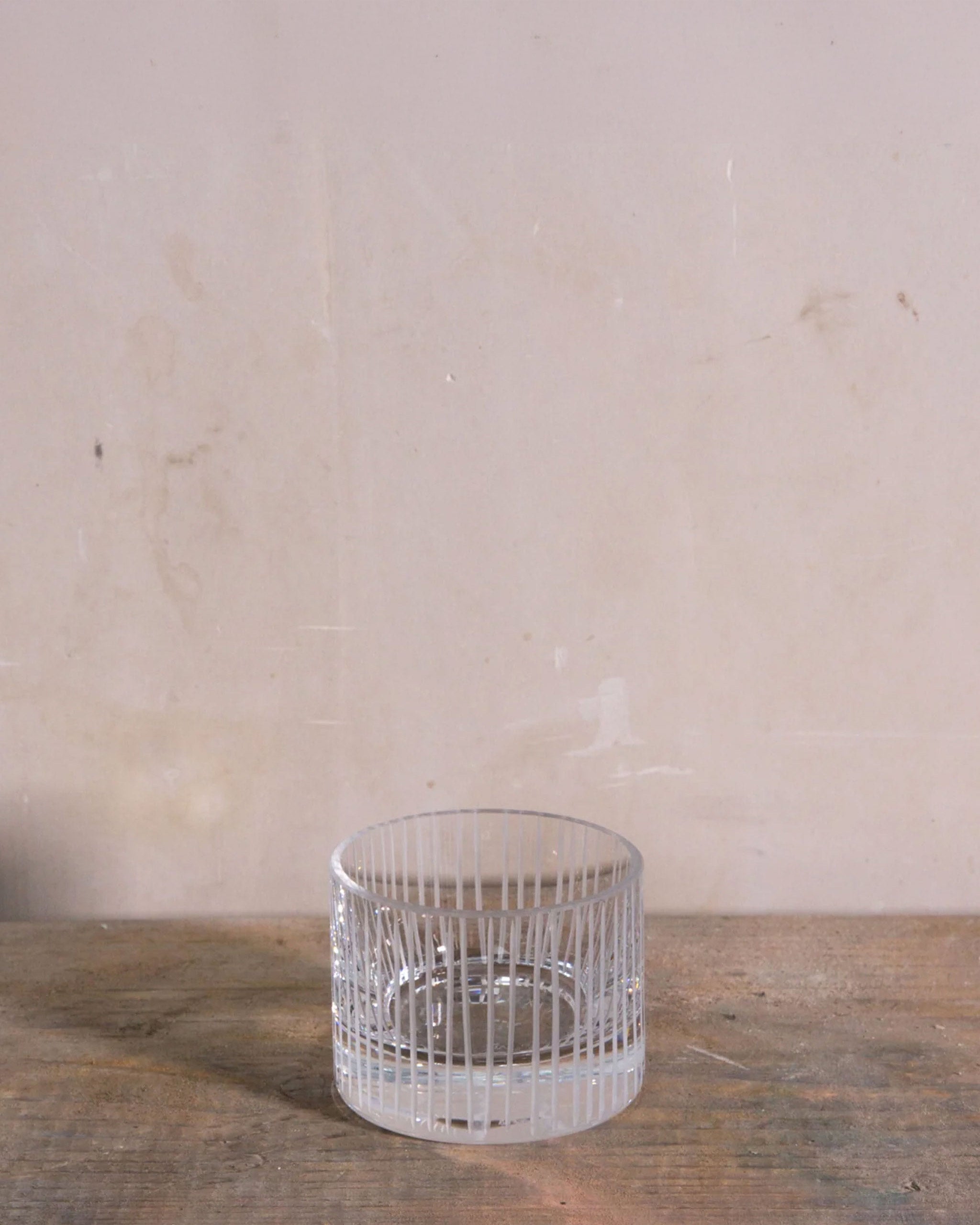 Short hand-blown and hand-cut Irish crystal votive from the Row Collection, shown with beeswax candles, creating a warm, tactile, and luminous display.