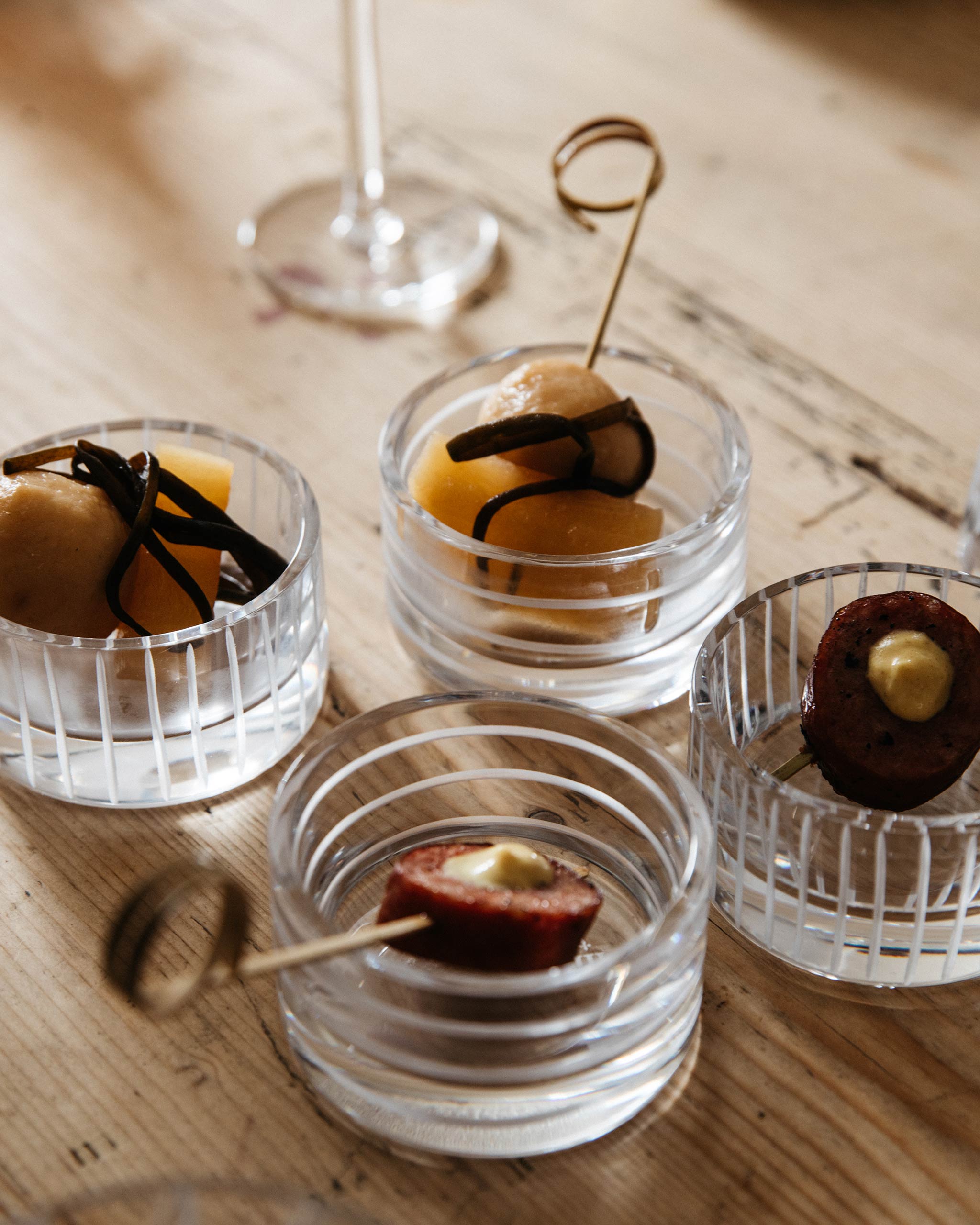 Loop crystal votive holding artistic nibbles styled in a festive lifestyle setting that highlights light, texture, and seasonal warmth.