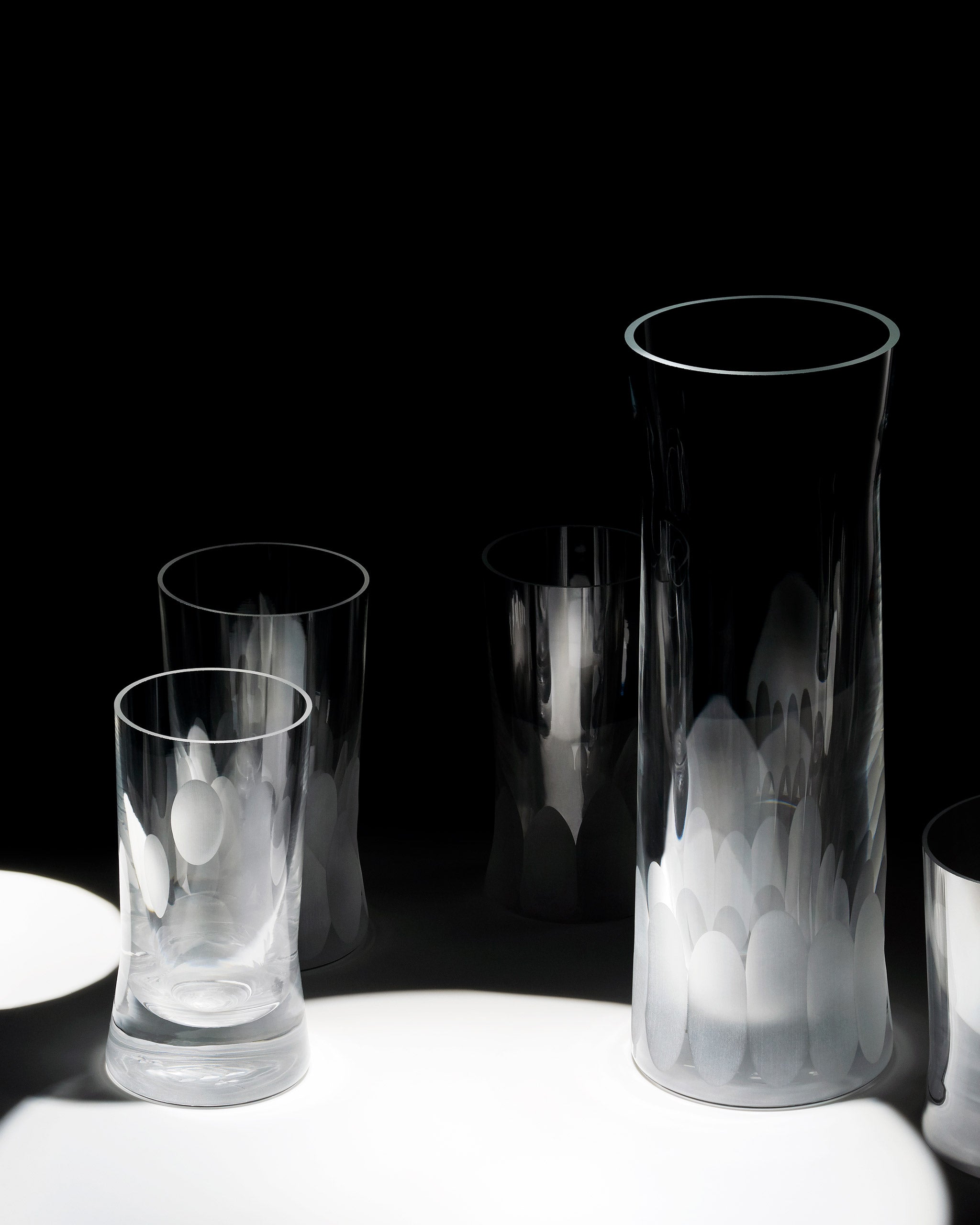 Array of unpolished Irish hand-blown cut crystal glasses, with ambient lighting to showcase unpolished cut detailing