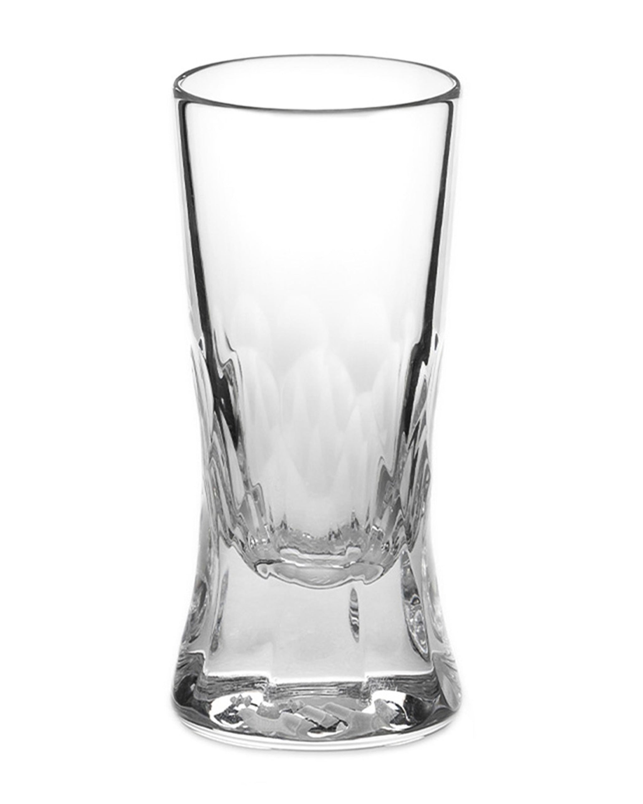 Polished Irish hand-blown cut crystal shot or grappa glass with large cut pattern detailing on a white background