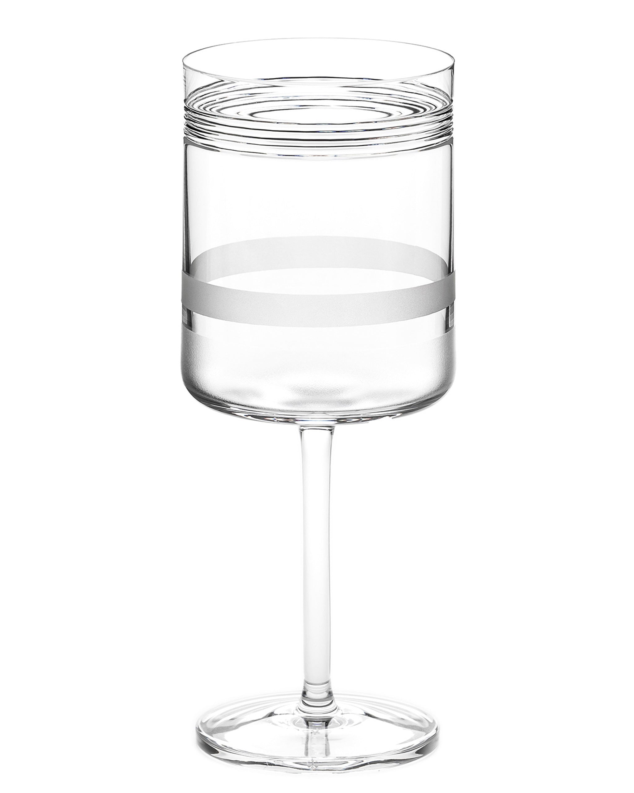 Red wine glass with cut crystal pattern and sandblasted panels that refract light and highlight ruby tones.