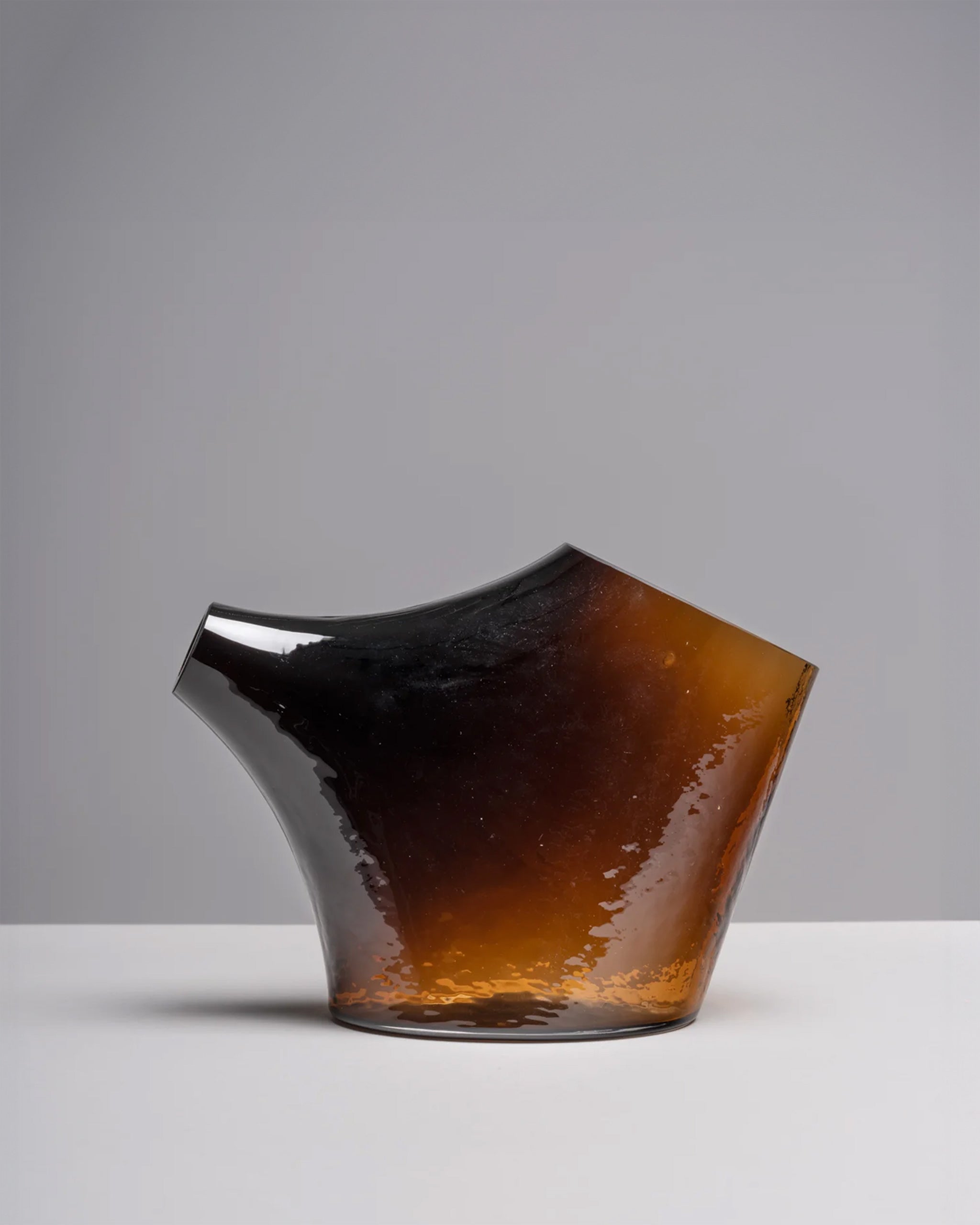 HopStep pot in kiln-cast blown glass shown on a white background to highlight its sculptural, organic form.