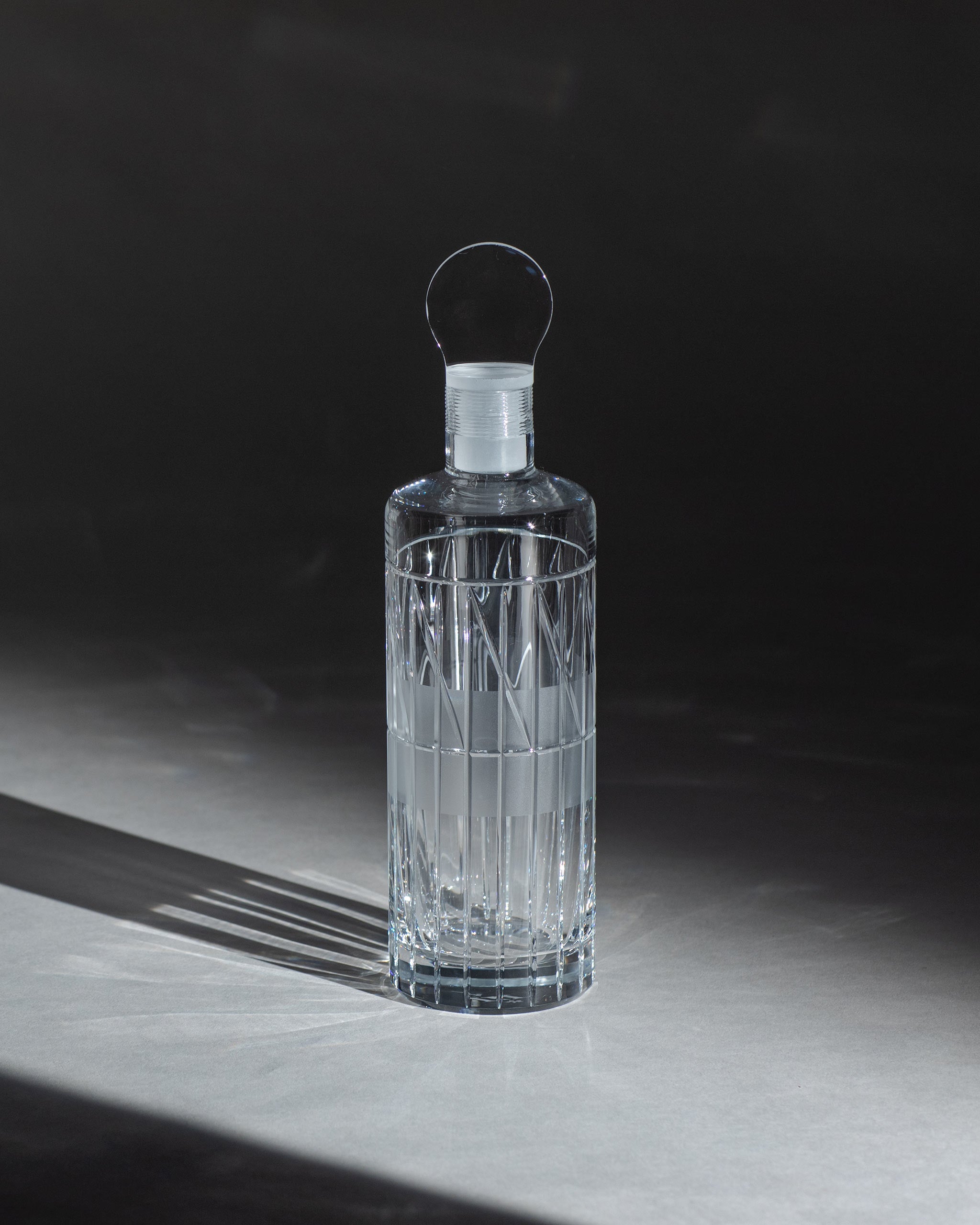Hand-blown whiskey decanter with stopper, modern cut crystal design design on an ambient background