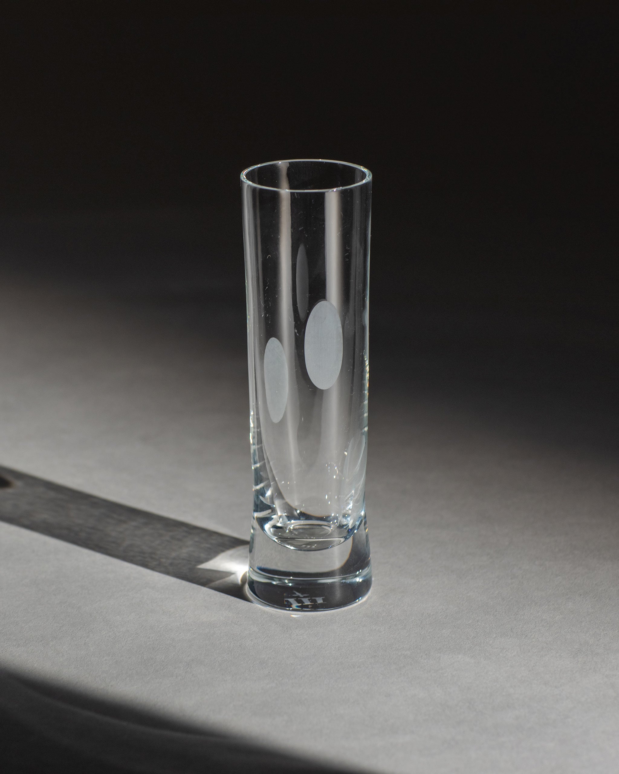 Unpolished hand-cut Irish crystal champagne flute with softly polished and sandblasted dew-cut detailing on an ambient background