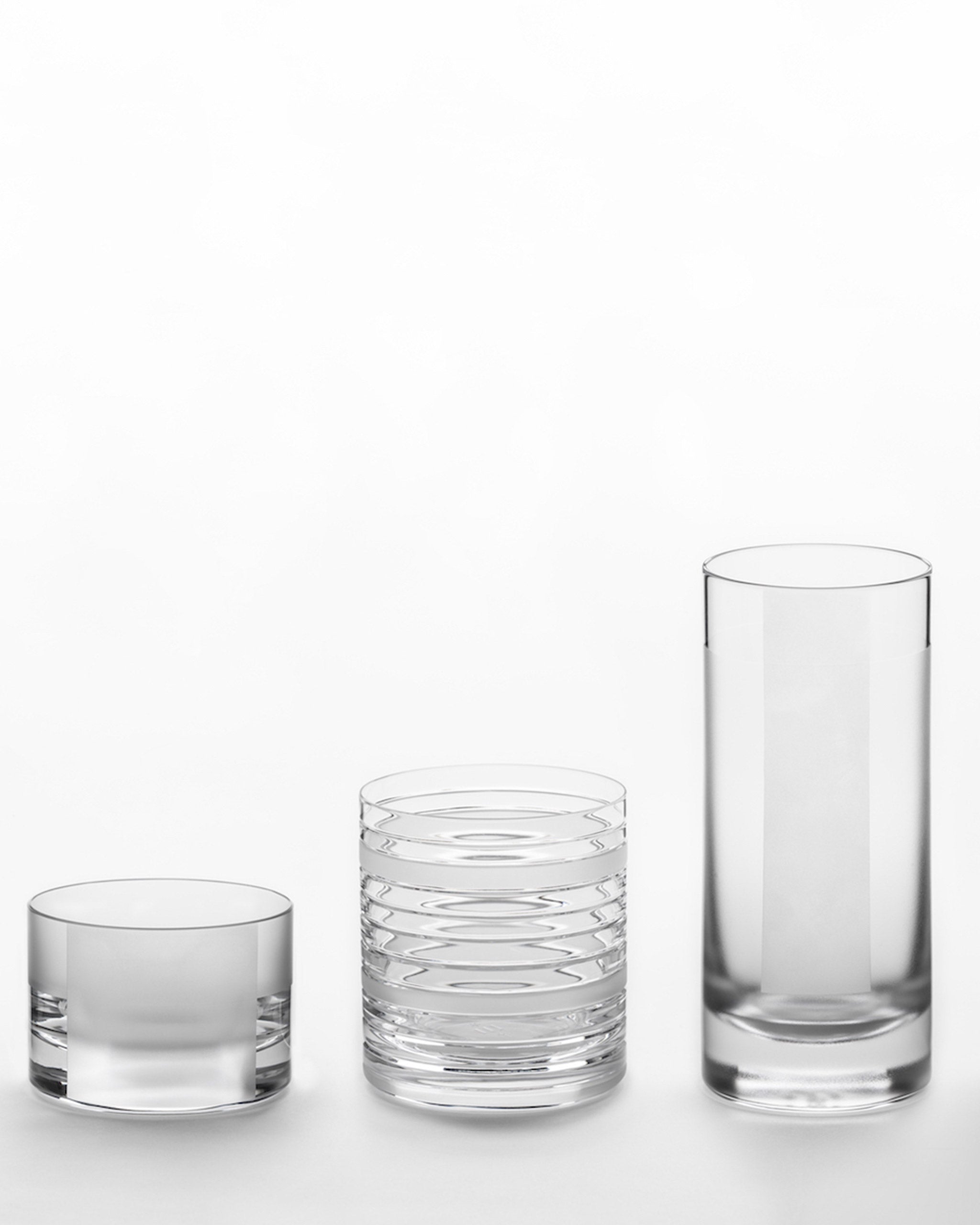 Trio of hand-blown cut crystal glassware sit on a white background