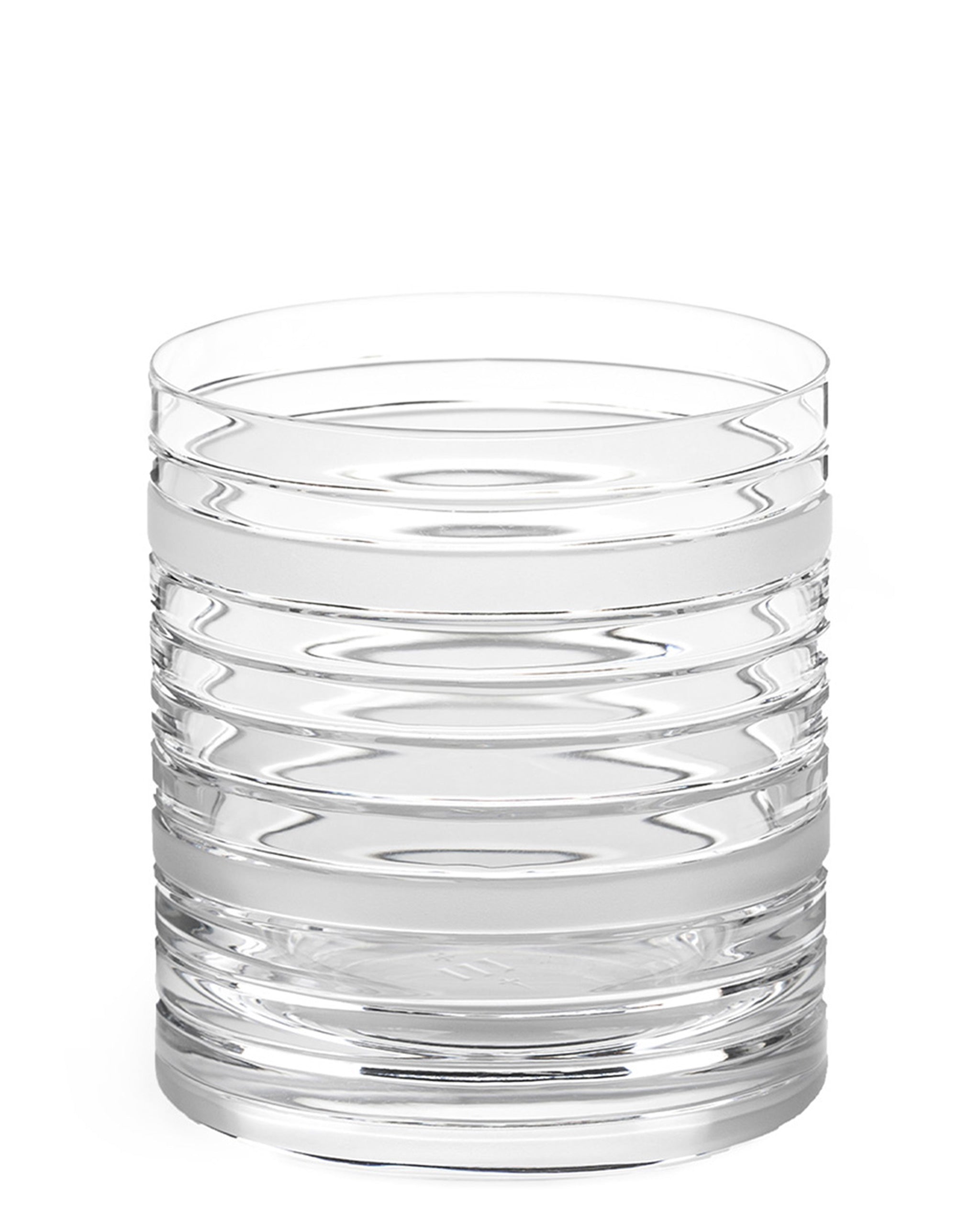 Handcrafted crystal tumbler with sharp horizontal cuts and sculptural design, perfect for whiskey or spirits.