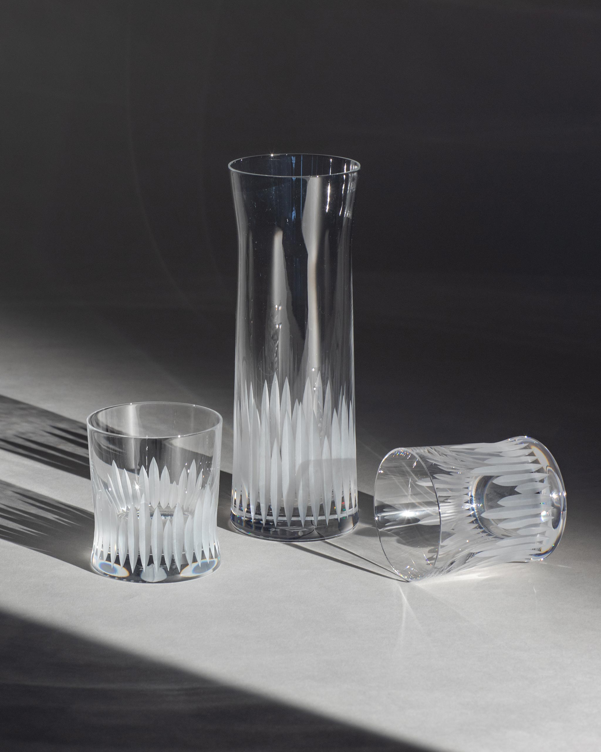 Unpolished hand-cut Irish crystal glasses with distinct cut design on an ambient background