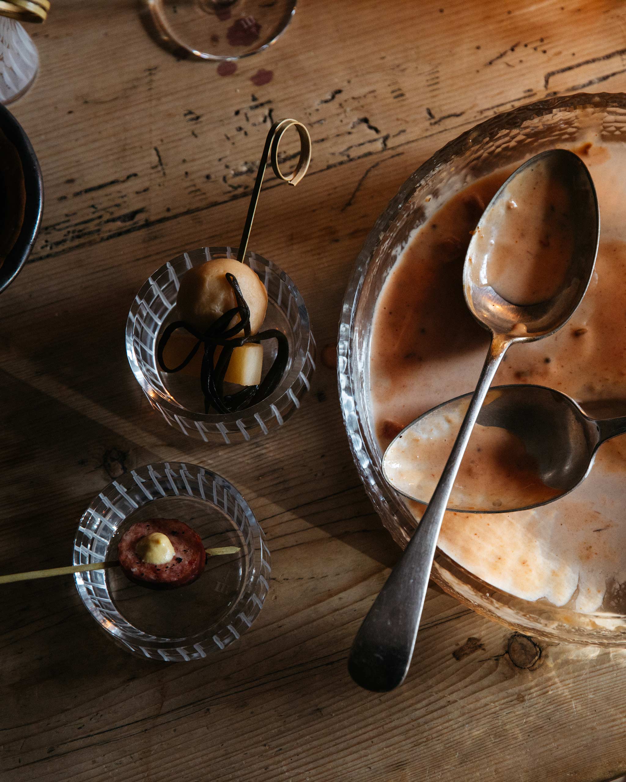 Hand-cut Irish crystal votive from the Row Collection used for serving festive nibbles on a dining table, surrounded by an empty plate and cutlery for a lifestyle setting