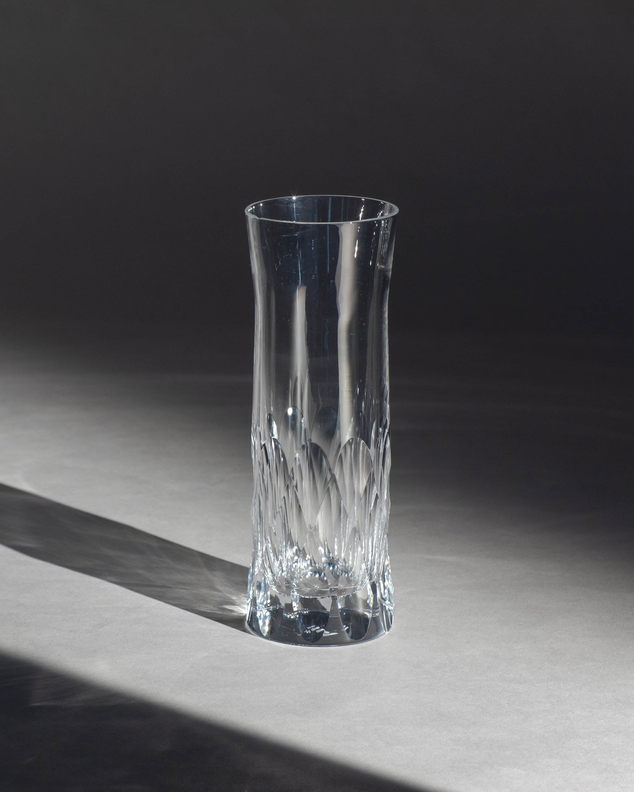 Polished Irish hand-blown cut crystal carafe glass, perfect for wine or as a vase, on an ambient background