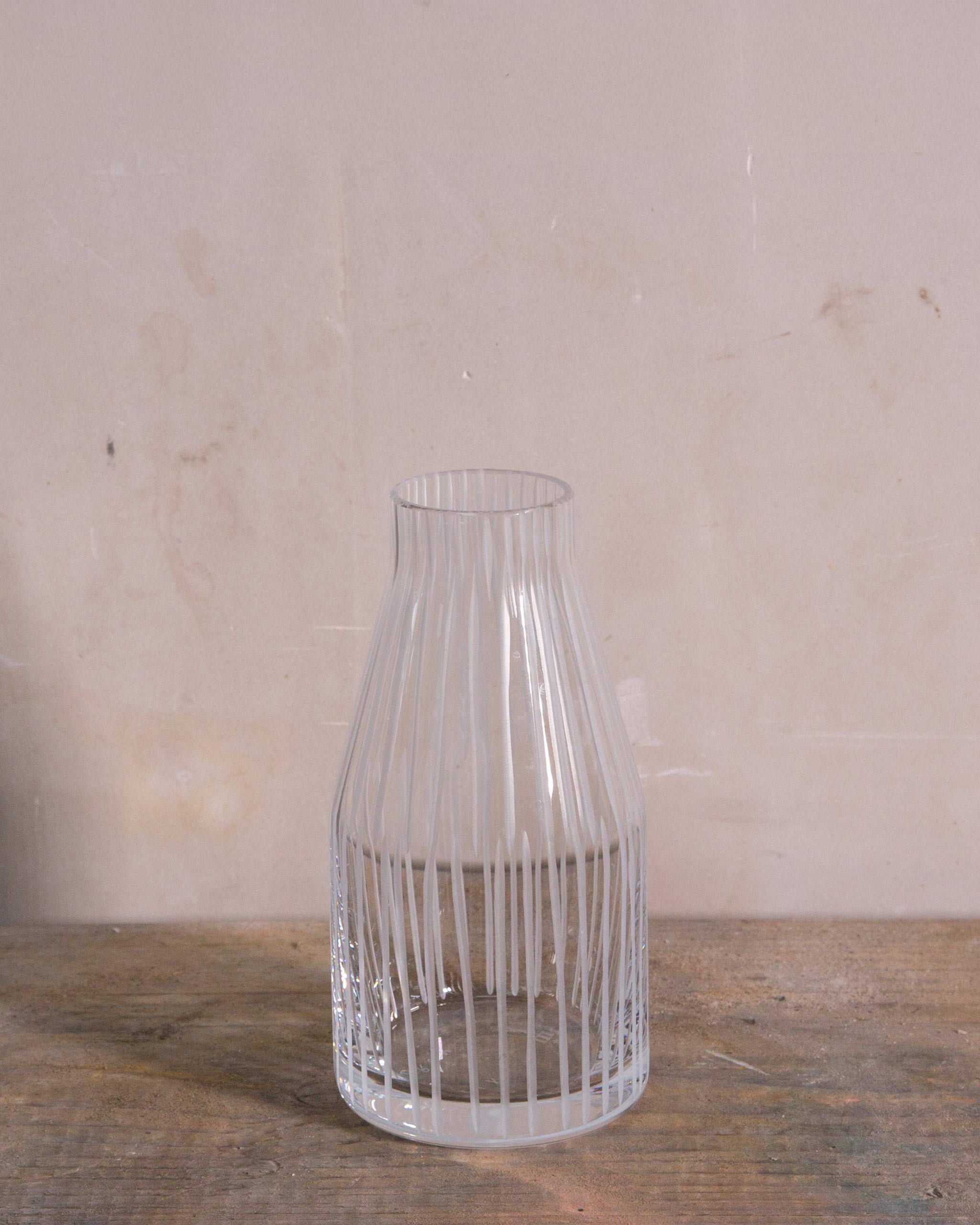 Elegant hand-blown Irish crystal carafe from the Row Collection with vertical cut detailing, versatile for serving sake, wine, water, or juice.