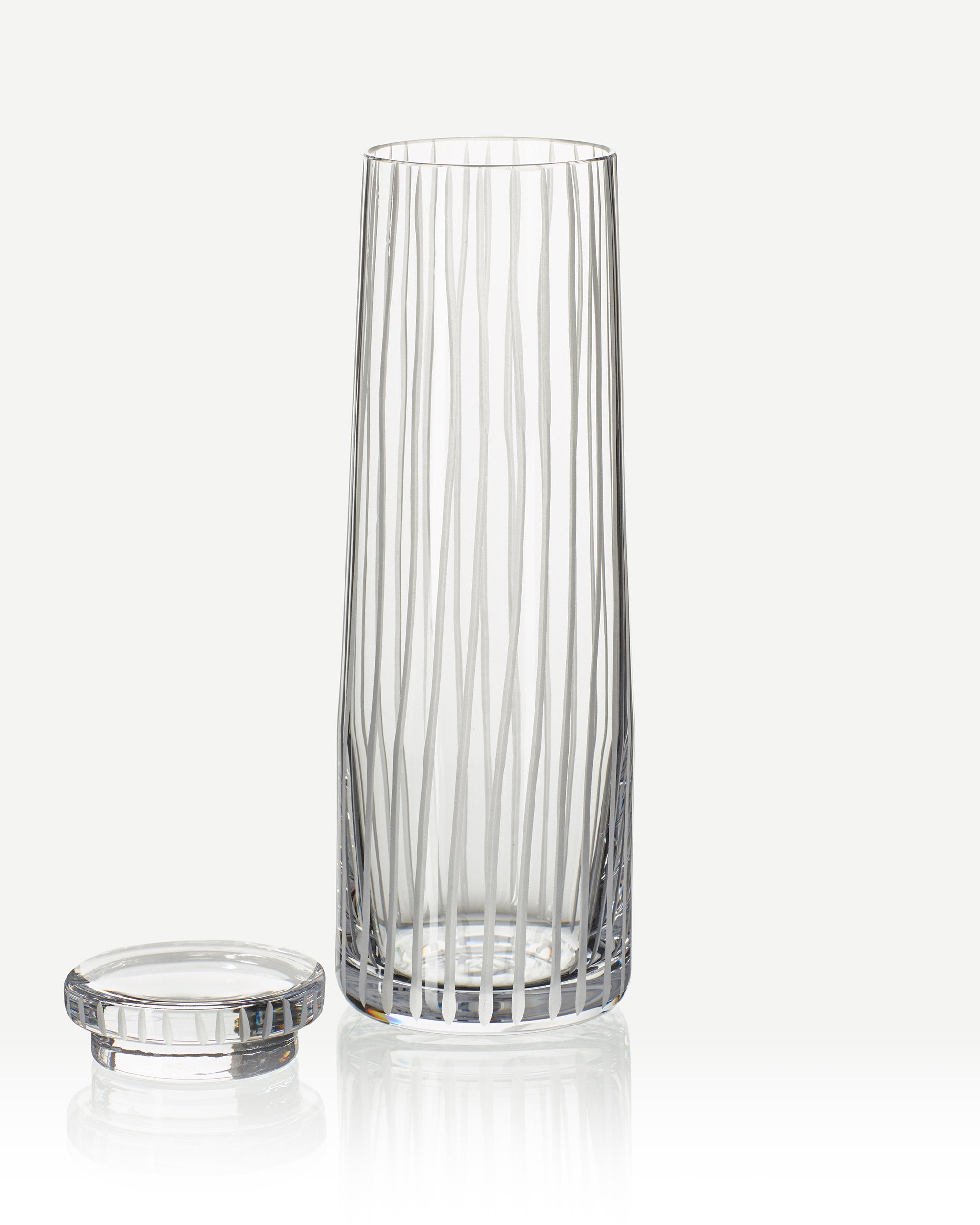 Hand-cut Irish crystal decanter with structured vertical cuts and broad base from the Row Collection on a white background