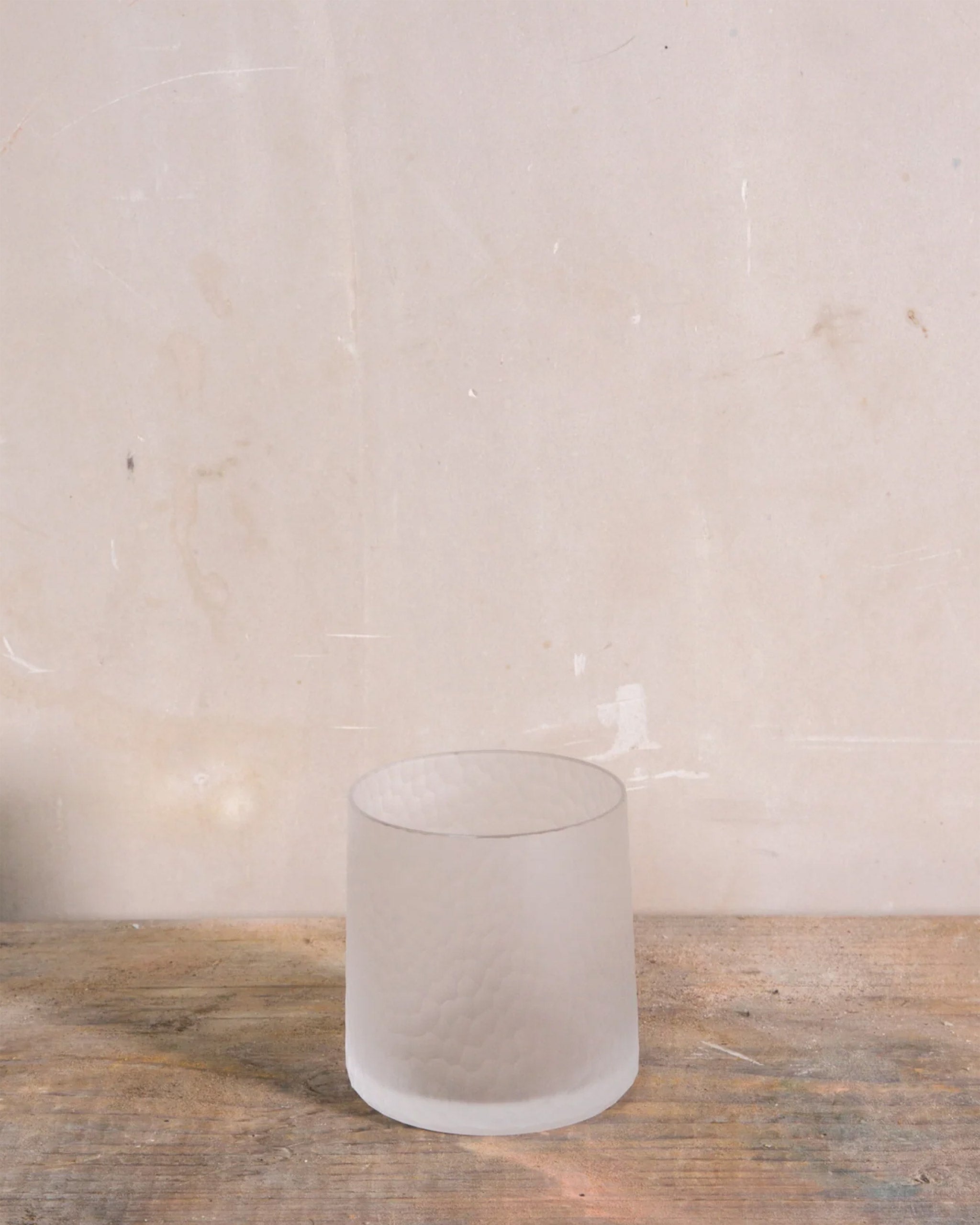 Hand-cut Irish crystal slant tumbler with softly diffused, rounded cuts, ideal for whiskey, wine, or sake on a natural background