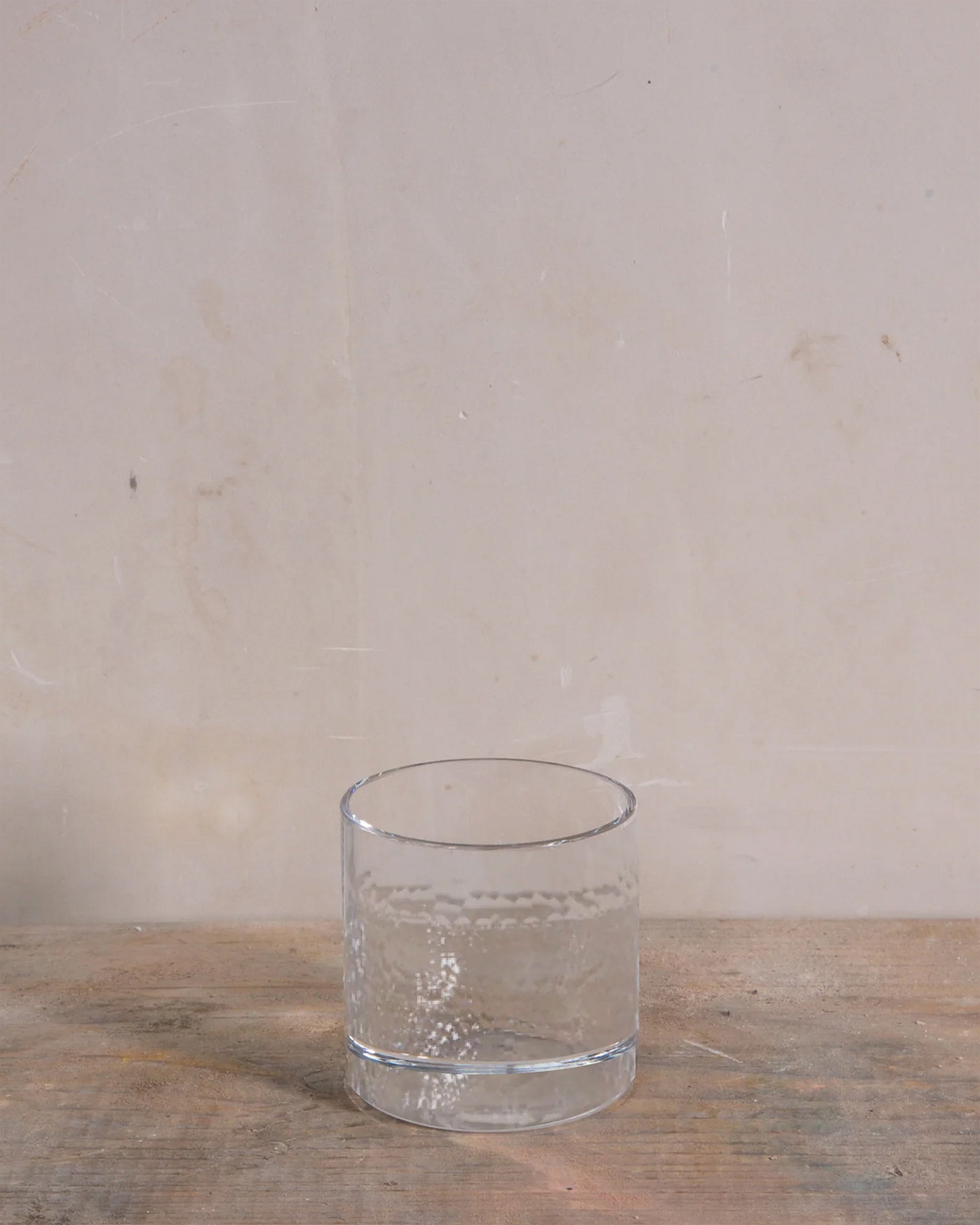 Polished hand-cut Irish crystal straight tumbler with softly diffused, rounded cuts, ideal for whiskey, wine, or sake on a natural background